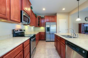 Kitchen, Stainless Steel Appliances, Pendant Lights, Dark Wood, Staggered Cabinets