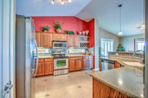 kitchen, granite, wine rack, tile, stainless steel appliances, pendant lights